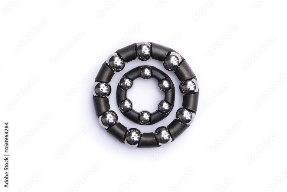 Close-up of two black roller bearings on a white background Close-up of two black roller bearings on a white background