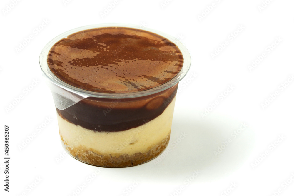Plastic tub with tasty cream and chocolate dessert on white background Plastic tub with tasty cream and chocolate dessert on white background