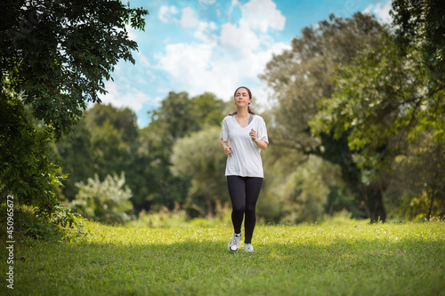 Fitness and wellness. A young caucasian athletic woman is jogging in the park