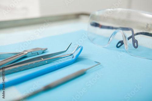 Close up cropped shot of dentists tools and eyeglasses