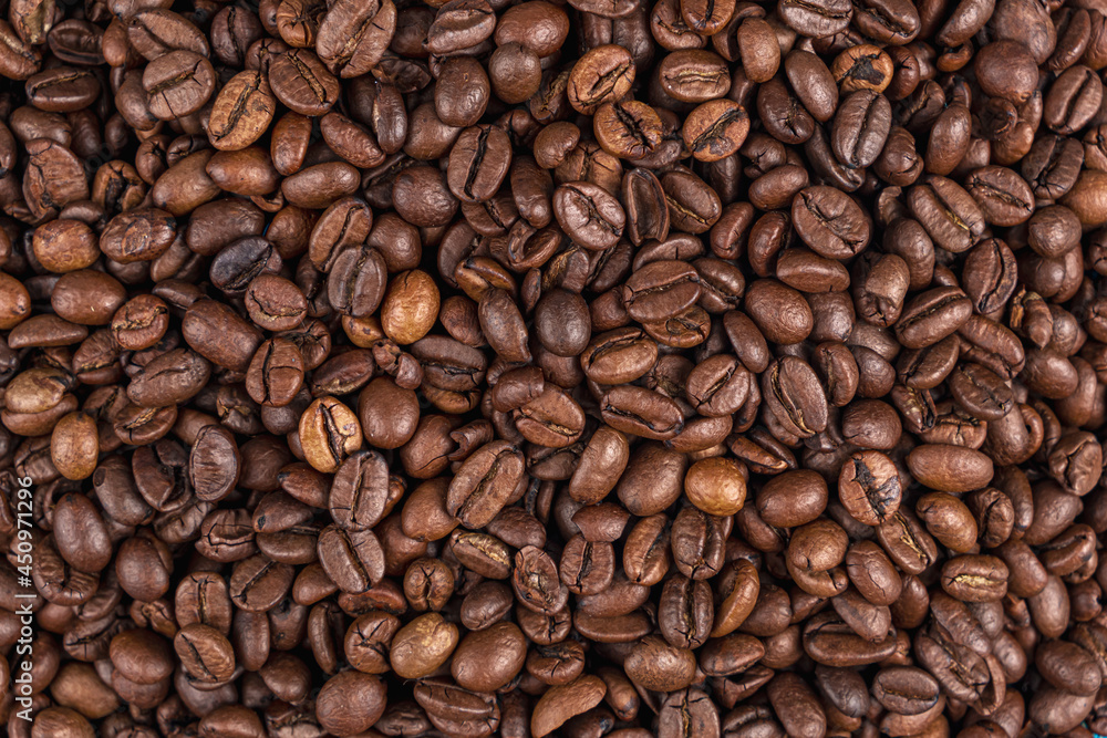 Roasted coffee beans on the table close-up. Texture. Background Roasted coffee beans on the table close-up. Texture. Background