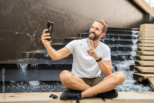 Model Man With Beard Smiling And Taking Selfie. 