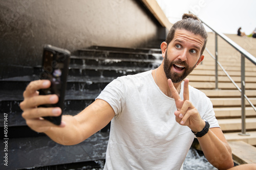 Model Man With Beard Smiling And Taking Selfie. 