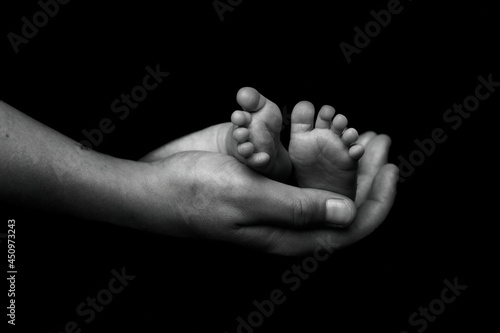 parent holding newborn feet