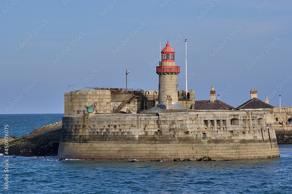Beautiful creative evening view of red East Pier lighthouse in Dun Laoghaire harbor seen from West Pier, Dublin, Ireland. Copy space. Soft and selective focus