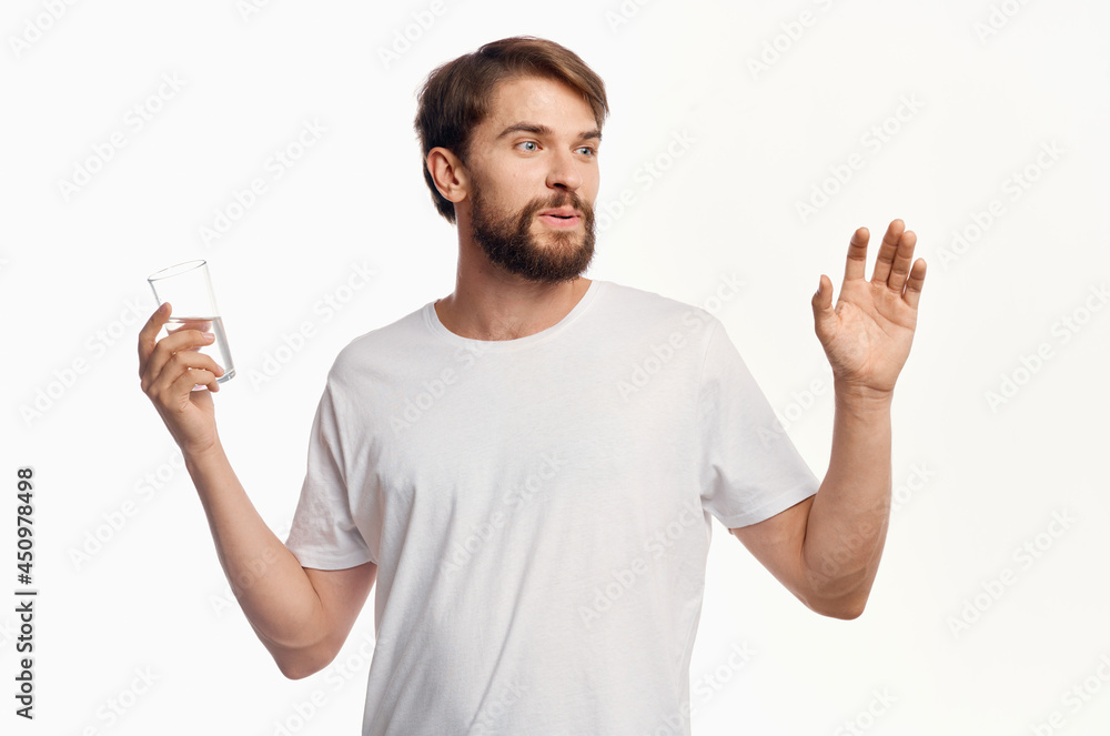 man in white t-shirt glass of water isolated background man in white t-shirt glass of water isolated background