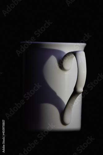 white mug with handle forming hear silhouette