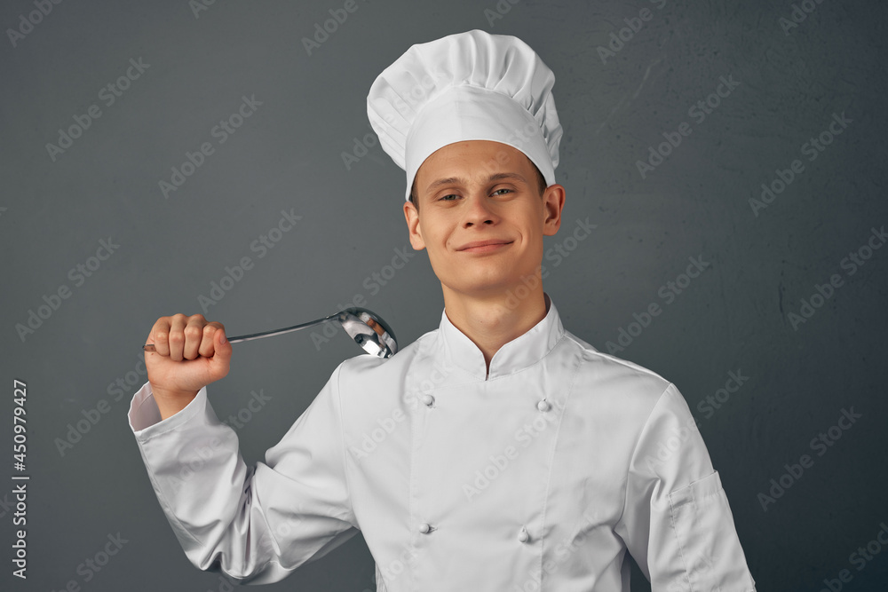 a man in a chef's uniform with a ladle in his hands cooking food kitchen professional