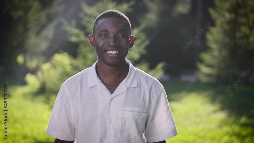 Portrait of a happy African man in the park. The guy smiles and looks at the camera. Portrait of a happy African man in the park. The guy smiles and looks at the camera.