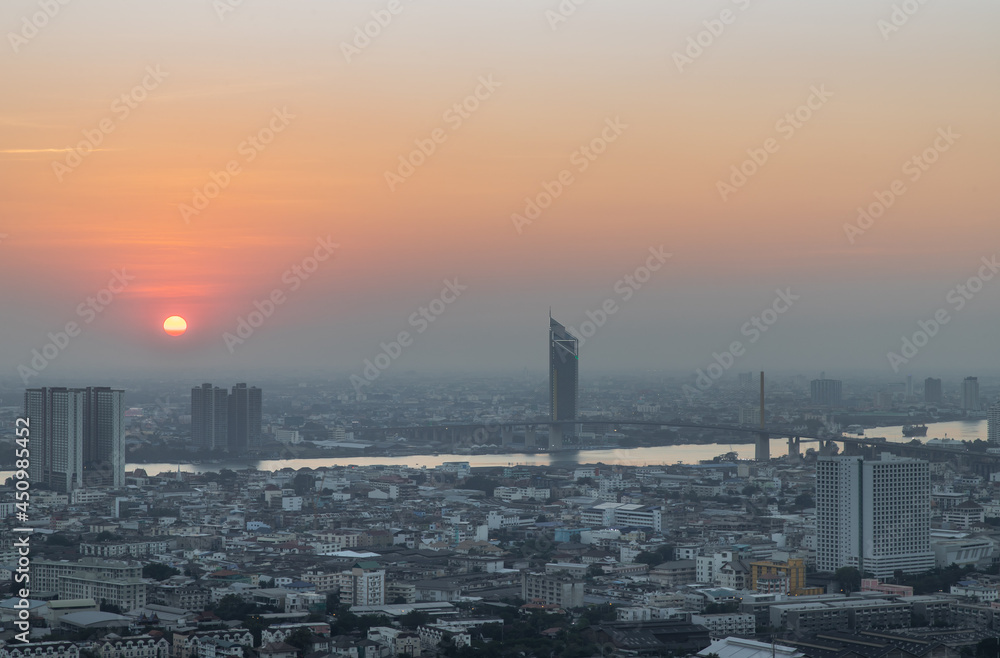 Naklejka premium Aerial view of Amazing beautiful scenery view of Bangkok City skyline and skyscraper before sun setting creates relaxing feeling for the rest of the day. Evening time, Selective focus.