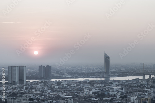 Aerial view of Amazing beautiful scenery view of Bangkok City skyline and skyscraper before sun setting creates relaxing feeling for the rest of the day. Evening time, Selective focus.