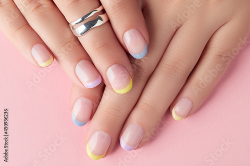 Fototapeta Close up manicured womans hands on pink background