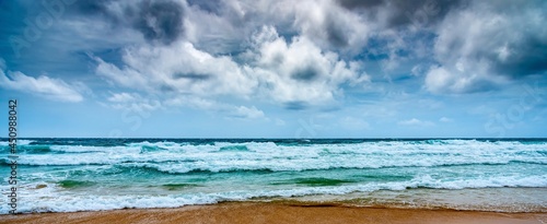 Beach and sea with overcast sky in windy day.