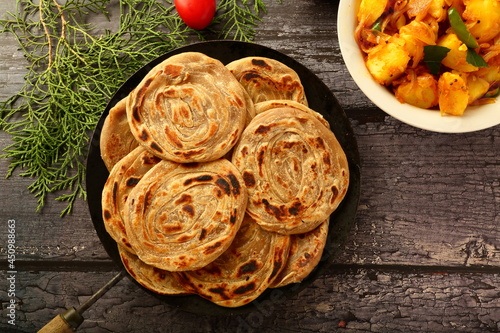 Indian food cuisine- healthy organic whole wheat paratha, porota  sertved with aloo paneer . vegetarian meal background. photo