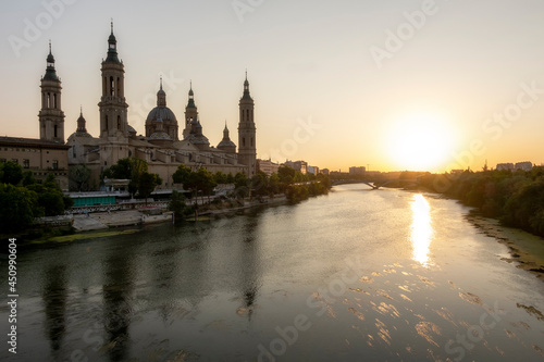View of Nuestra Se  ora del Pilar from the stone bridge at sunset on a hot summer day in Zaragoza.
