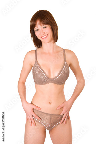 Closeup portrait of an attractive brunette woman wearing beautiful lingerie, isolated in front of white studio background