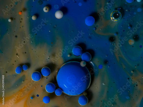 Colorful orange and blue bubbles wallpaper theme background. The concept of a multicolored cosmic universe. Fantastic hypnotic surface. Abstract pattern Chemical Reaction Texture Liquid paint Bubble m