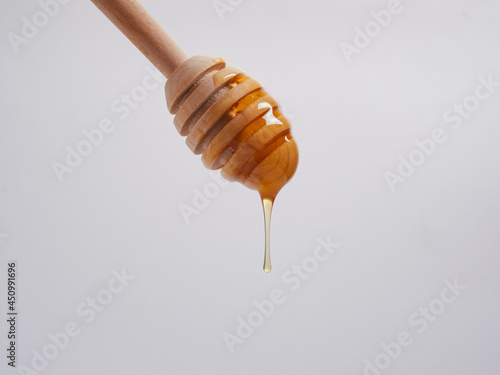 Honey pot and ladle isolated on a white background as a packaging design element