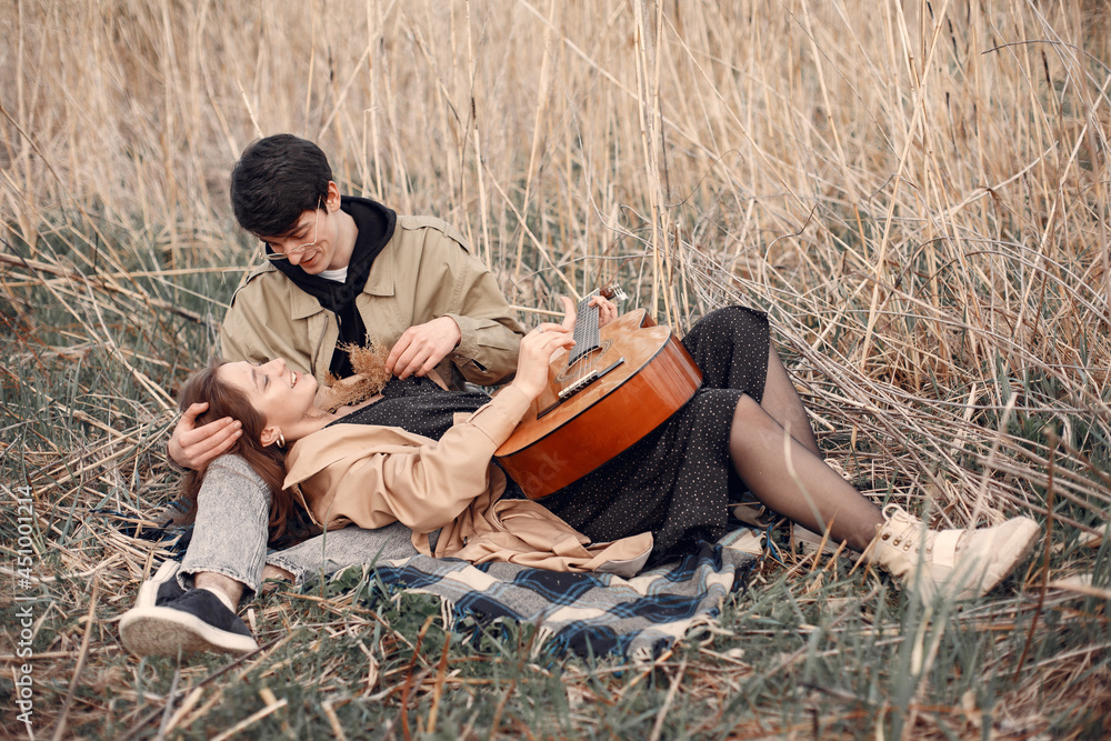 Beautiful couple spend time in a autumn field Beautiful couple spend time in a autumn field