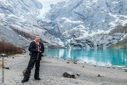 Tourist at amazing Briksdalsbre Briksdalsbreen glacier in the winder Norway.