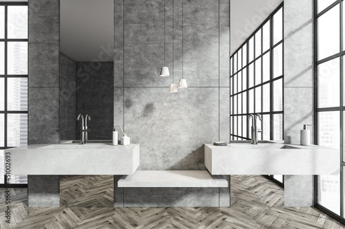 Bright bathroom interior with double sink and panoramic window