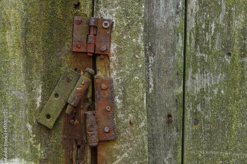 Rusty hinges on rotten doors. Background © Roman