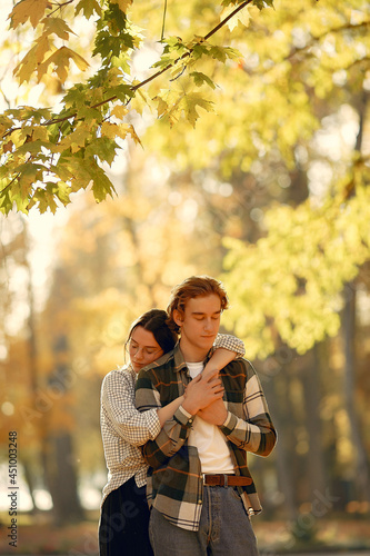 Beautiful couple spend time in a autumn park
