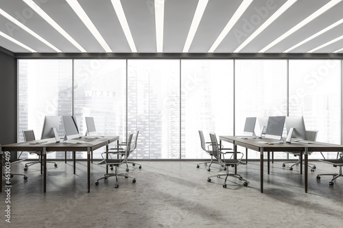 Panoramic grey office interior with two combined office desks