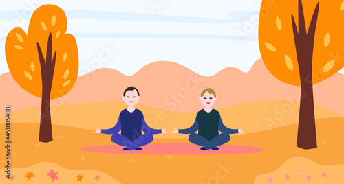 Two gay men doing yoga in an autumn park.