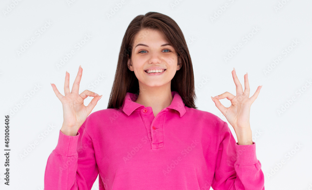 Attractive young adult woman showing two ok signs. Expression emotion and feelings concept. Studio shot, isolated on white background Attractive young adult woman showing two ok signs. Expression emotion and feelings concept. Studio shot, isolated on white background