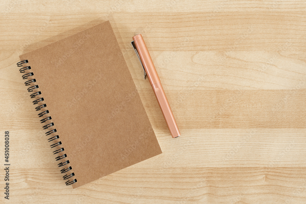 Rustic notebook and pencil on Wooden office desk. Top view with copy space. Flat lay. Rustic notebook and pencil on Wooden office desk. Top view with copy space. Flat lay.