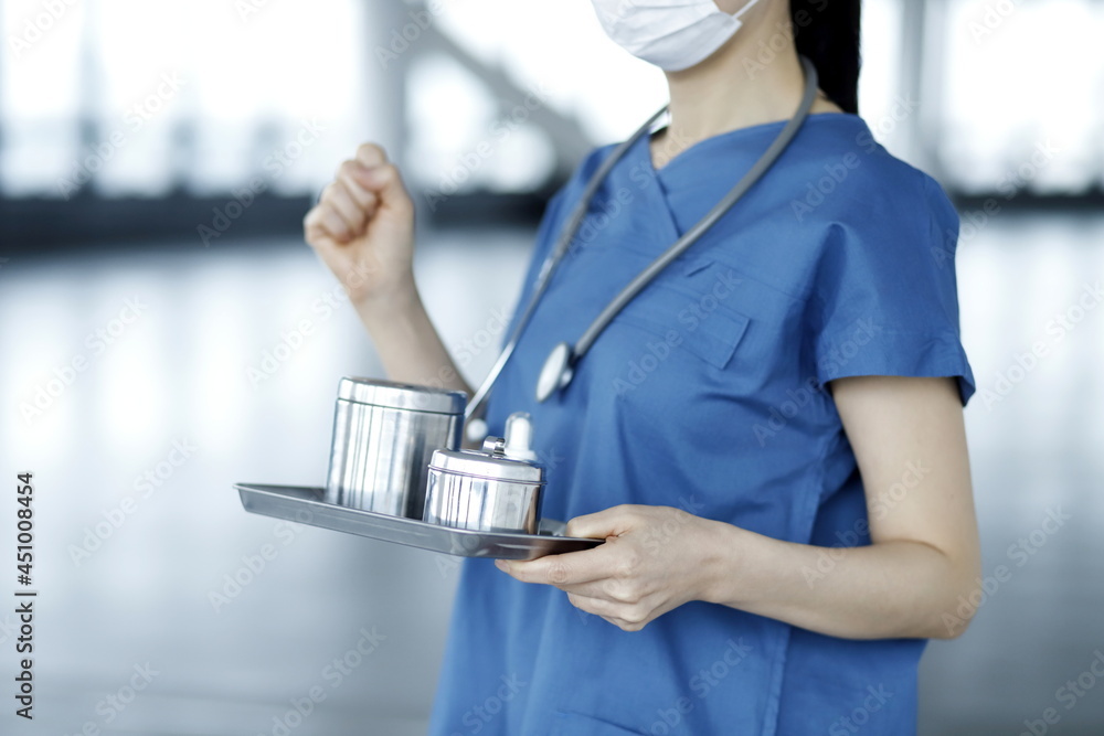 Close up of nurse holding medical tray Close up of nurse holding medical tray