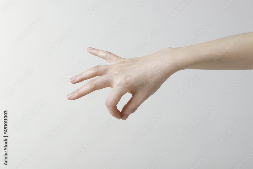 Cropped image of woman hand picking up something Cropped image of woman hand picking up something