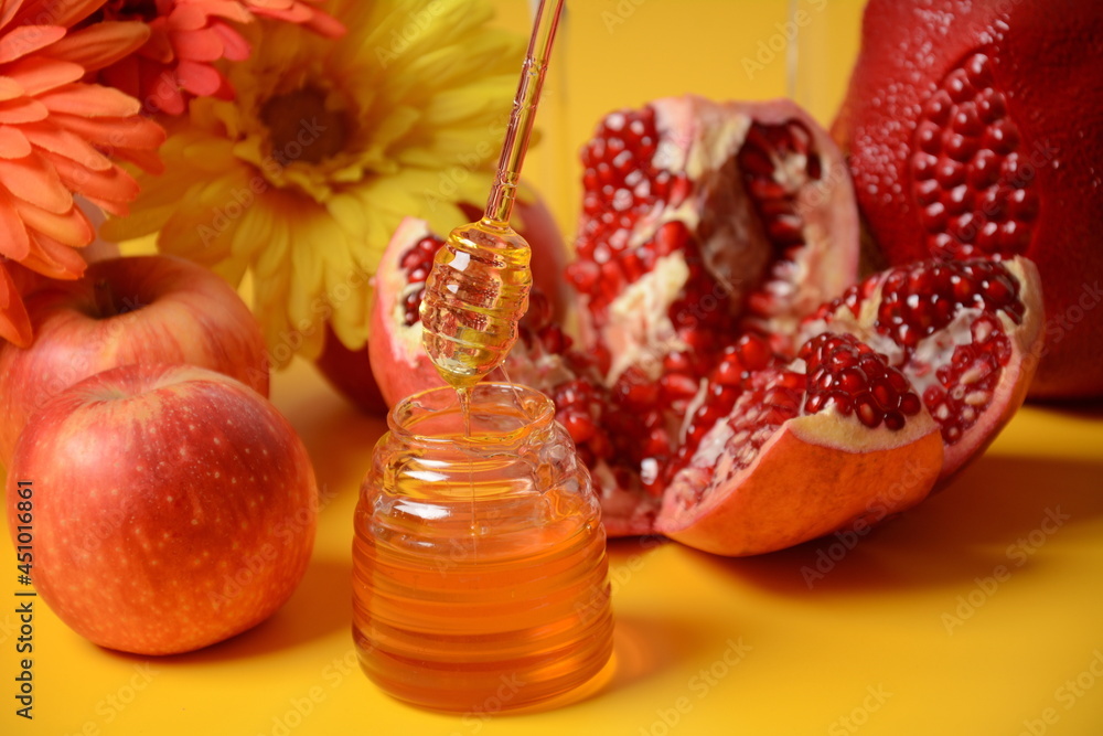 Rosh hashanah (jewish New Year holiday) concept. Traditional symbols-Honey jar, apples and pomegranate