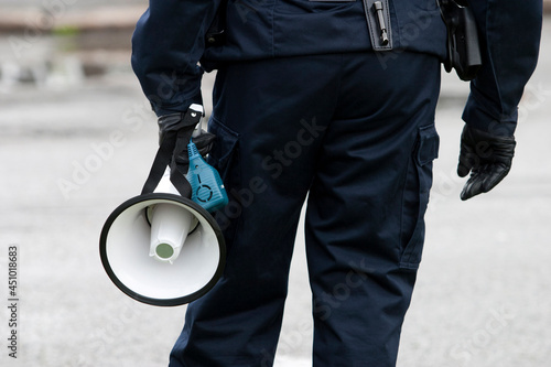 A Swedish police holding a bullhorn/megaphone