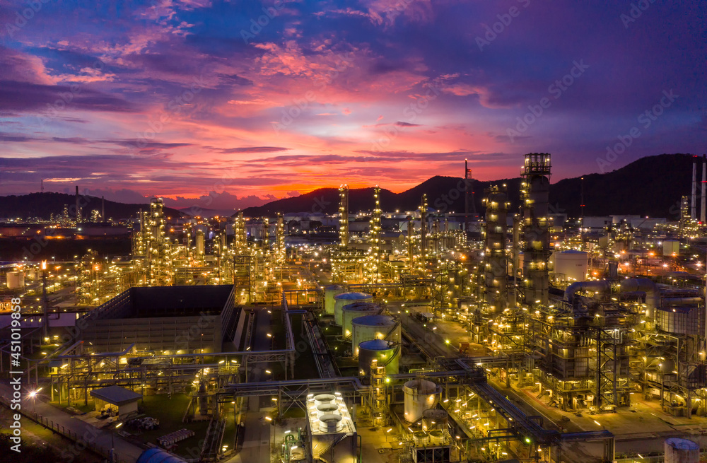 Obraz premium Aerial view Oil refinery. Industrial view at oil refinery plant form industry zone with sunrise and cloudy sky.
