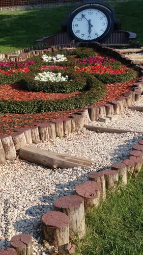 Landscape. Nature. Summer. Clock. Flowers. Flower bed. Landscaping.