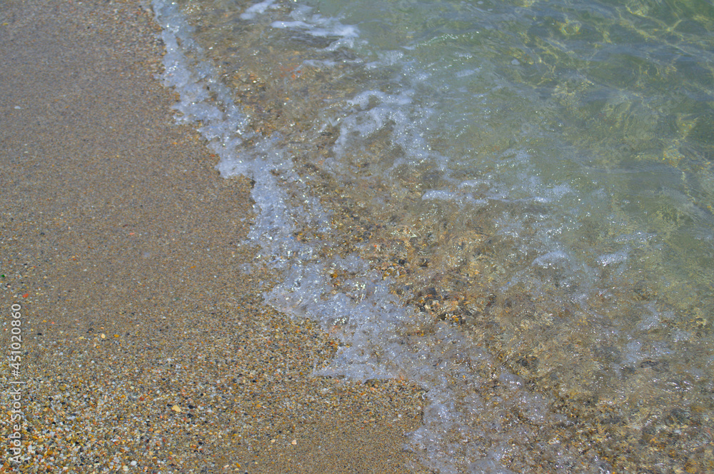 Beautiful view of the sea wave and sandy shore.