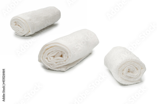 White fluffy cotton towel isolated on a white background.