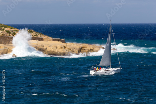 Yacht in rough seas on a sunny day