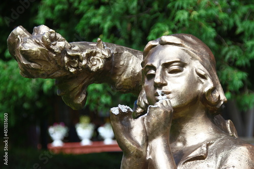 Sculpture of a young man made of concrete in the park photo