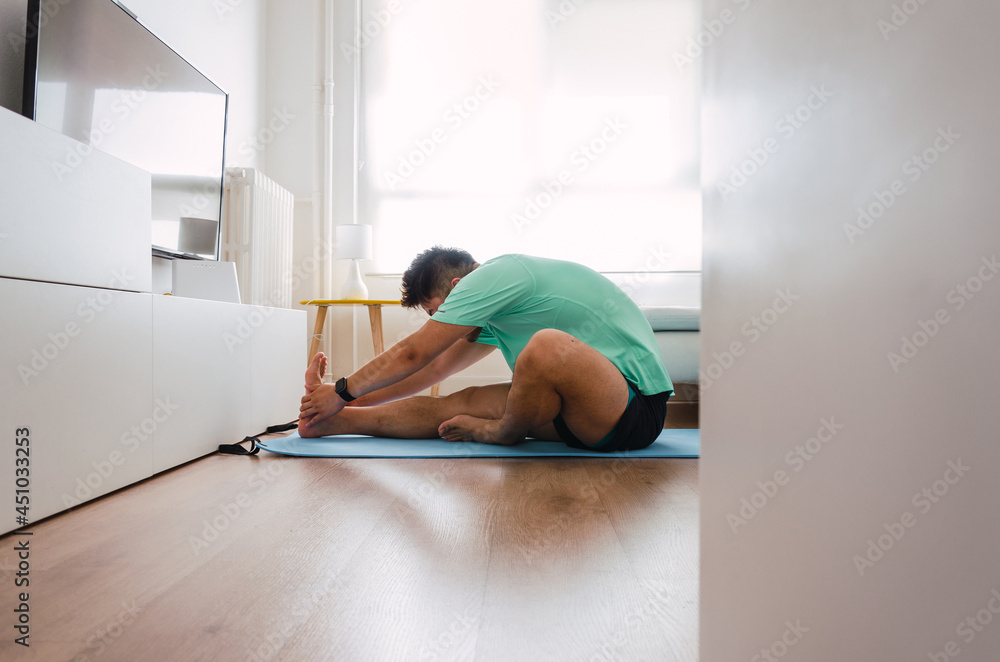 Young handsome Chinese man practicing yoga in the living room Young handsome Chinese man practicing yoga in the living room