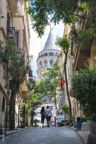Сouple in love walks through the historical streets of Istanbul. View of the Galata Tower