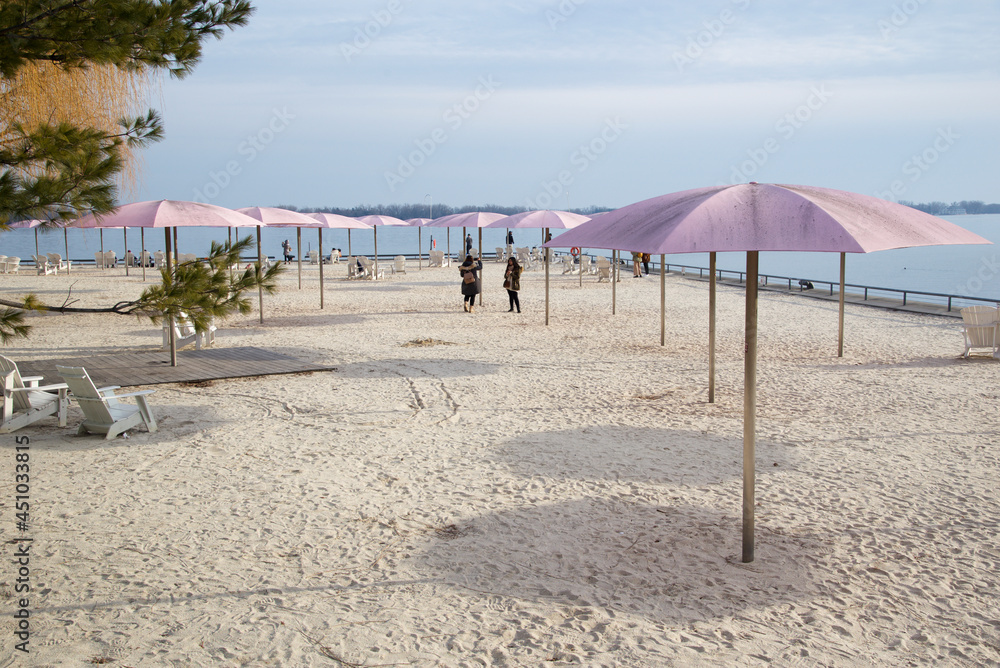 Beach chairs with umbrellas on a sunny day in winter Beach chairs with umbrellas on a sunny day in winter