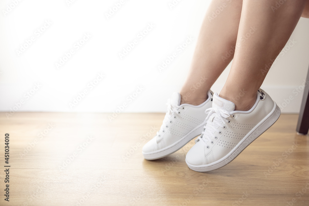 Woman in her white sneakers carefree fun Woman in her white sneakers carefree fun
