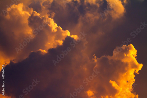 Fotografie Sunset Paints Gathering Storm Clouds a Dramatic Orange.