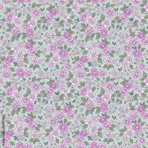 Seamless floral pattern. Ditsy background of small lilac and purple flowers. Small-scale flowers scattered over a green gray  background. Stock vector for printing on surfaces and web design. © ann_and_pen