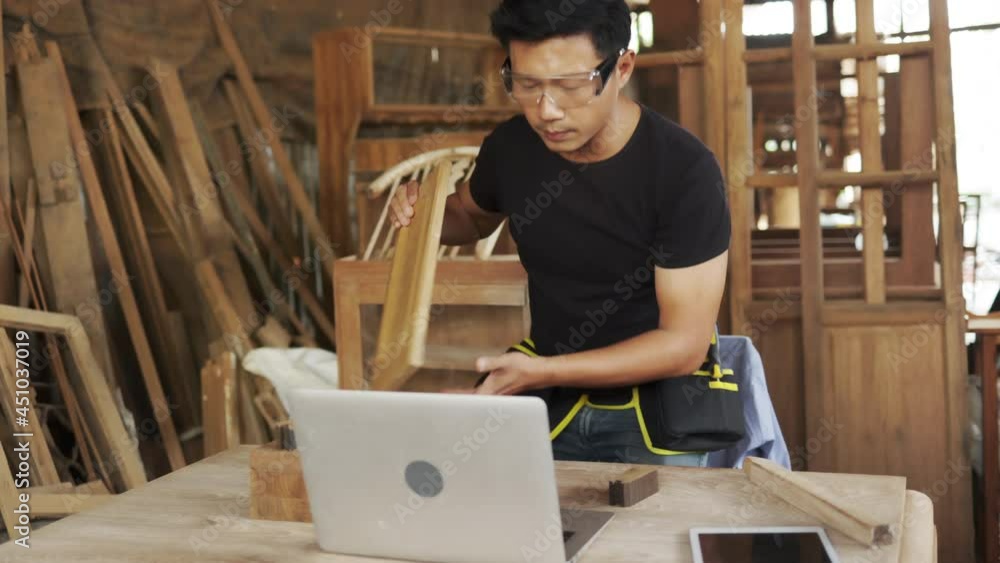 Two asian carpenters in a construction workshop. business man and woman working together woodwork.Friends in a construction workshop, learning carpentry. Two asian carpenters in a construction workshop. business man and woman working together woodwork.Friends in a construction workshop, learning carpentry.