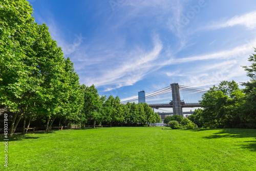 Brooklyn Bridge stands beyond the East River from Lawn of the Brooklyn Bridge Park amidst Pandemic of COVID-19 on June 18, 2021 in New York City, USA.