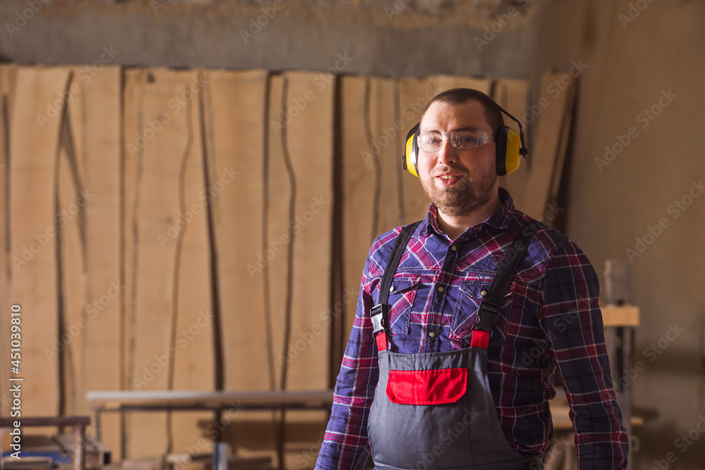the carpenter wearing safety clothes in the factory the carpenter wearing safety clothes in the factory